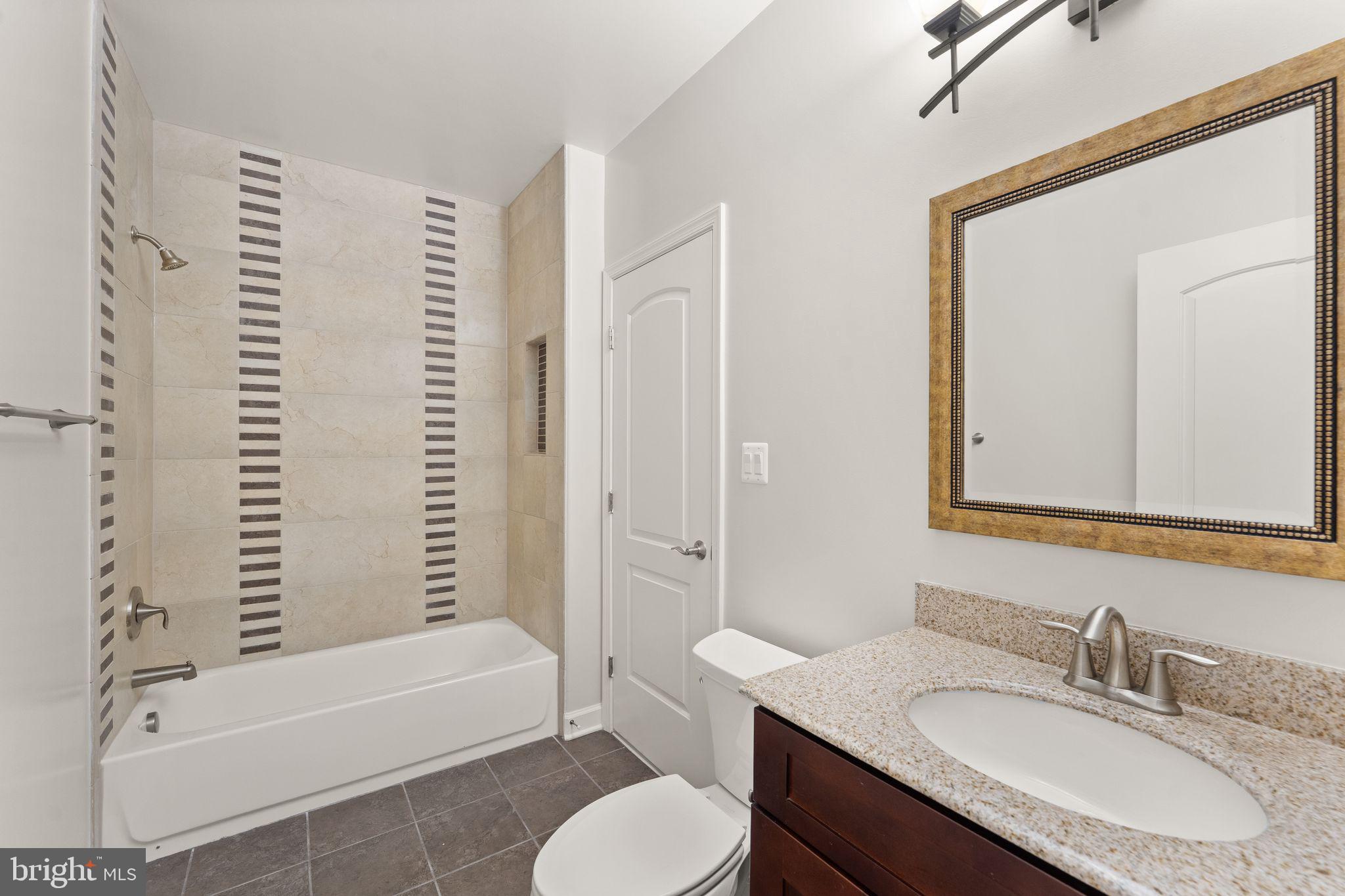 3906 Estel Road Fairfax, VA 22031 - Photo 106 of 122 a bathroom with a granite countertop sink toilet tub and shower