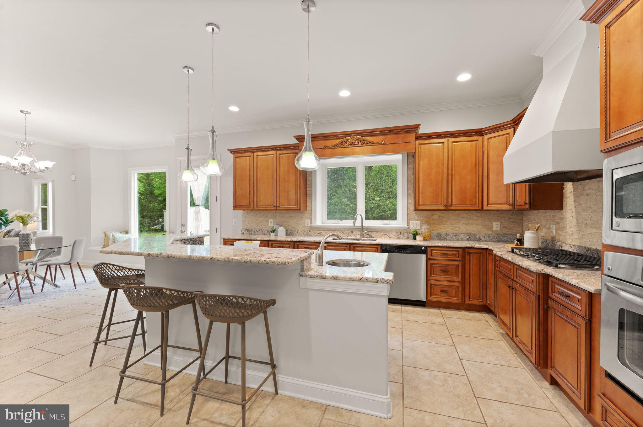 3906 Estel Road Fairfax, VA 22031 - Photo 36 of 122 a kitchen with stainless steel appliances granite countertop a stove top oven a sink dishwasher a dining table and chairs with wooden floor