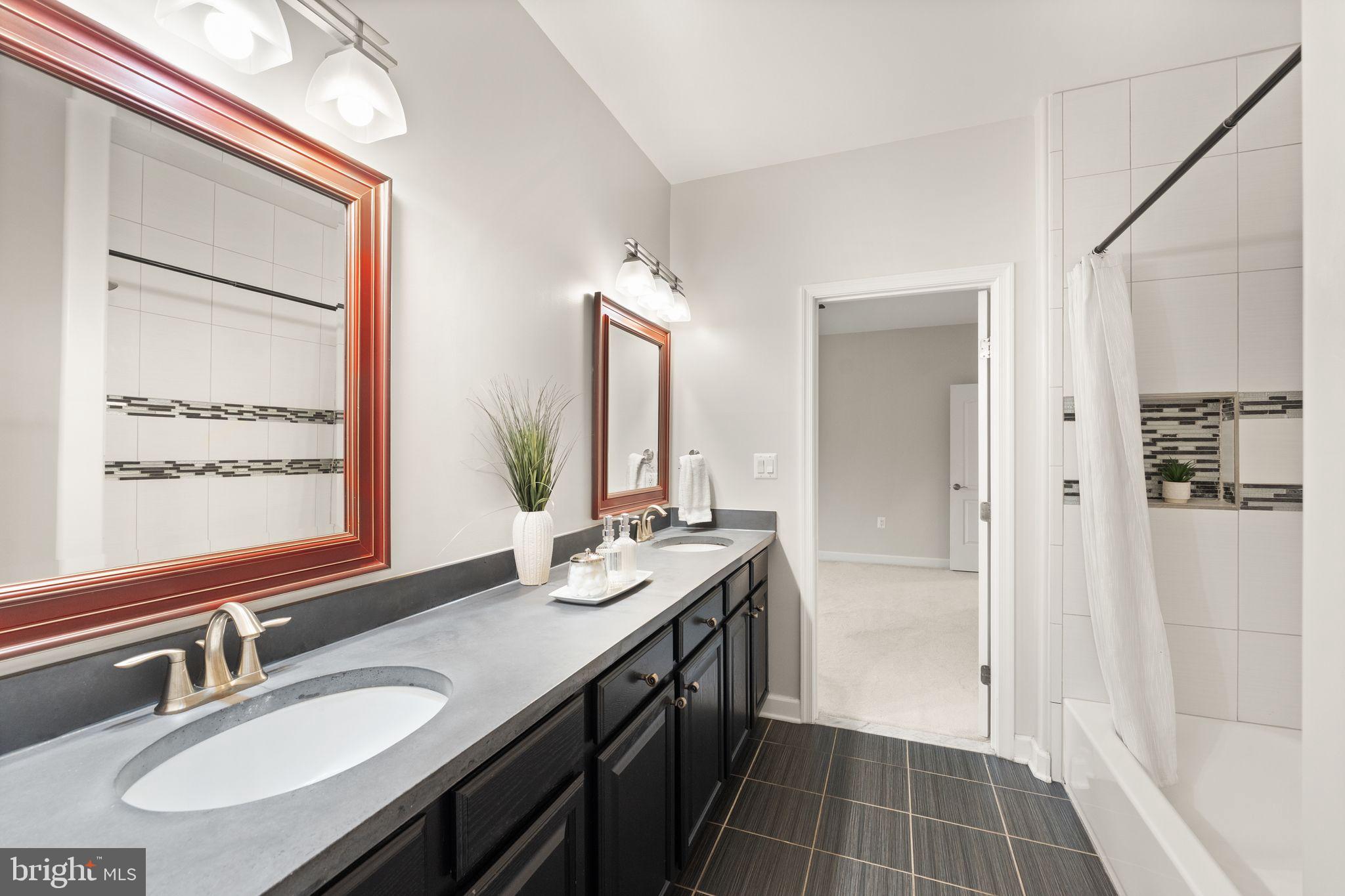 3906 Estel Road Fairfax, VA 22031 - Photo 75 of 122 a bathroom with a double vanity sink a mirror and a shower