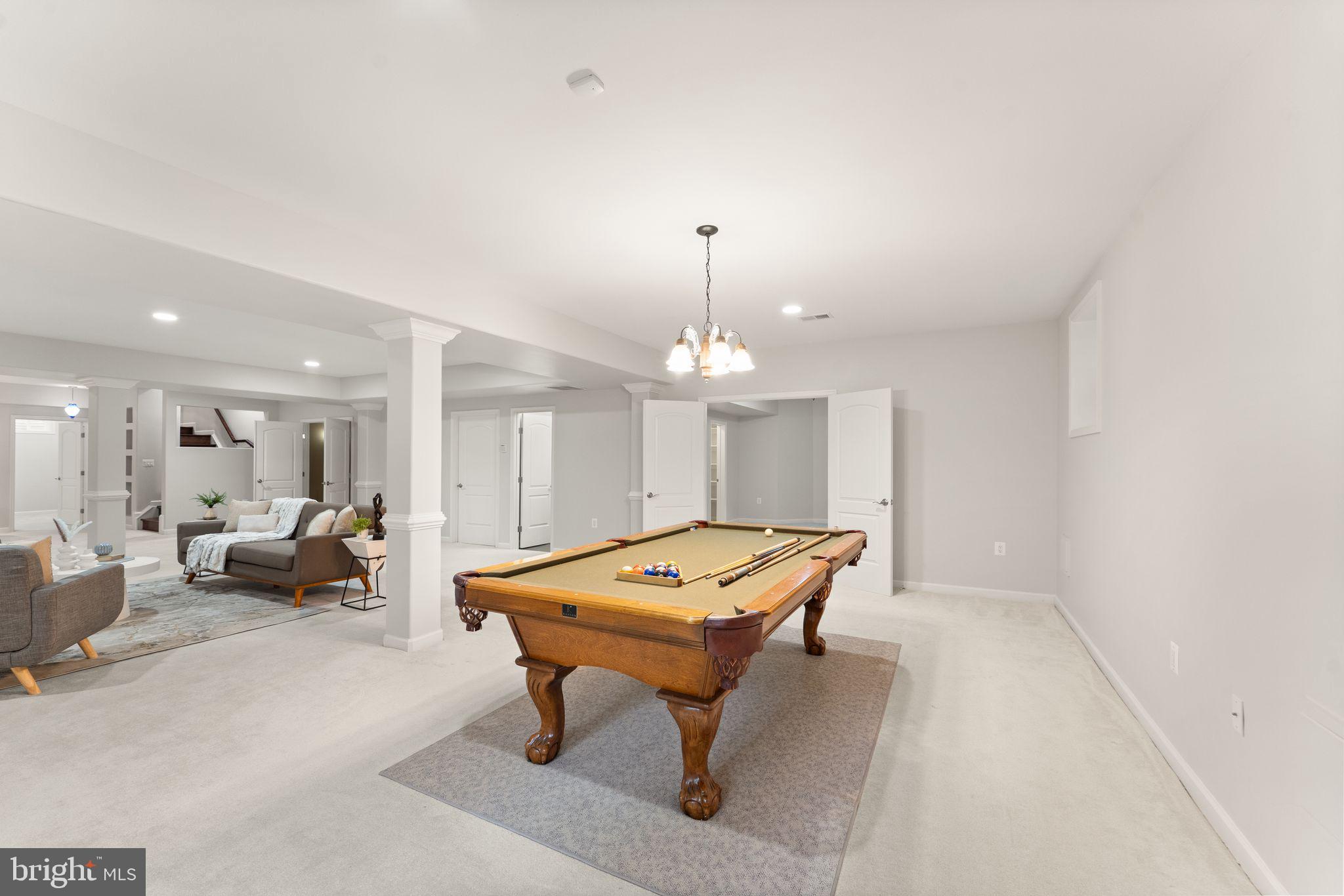 3906 Estel Road Fairfax, VA 22031 - Photo 97 of 122 a living room with furniture a table and a chandelier