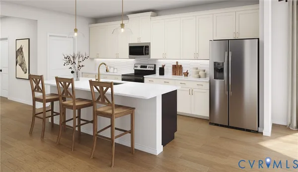 a kitchen with stainless steel appliances a refrigerator stove microwave and white cabinets