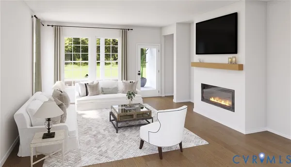 a living room with furniture a flat screen tv and a fireplace