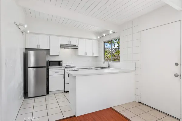 a kitchen with a white cabinets and white appliances