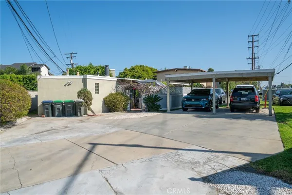 a view of house with outdoor space and parking