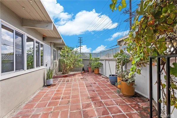 a view of a porch with plants and wooden floor