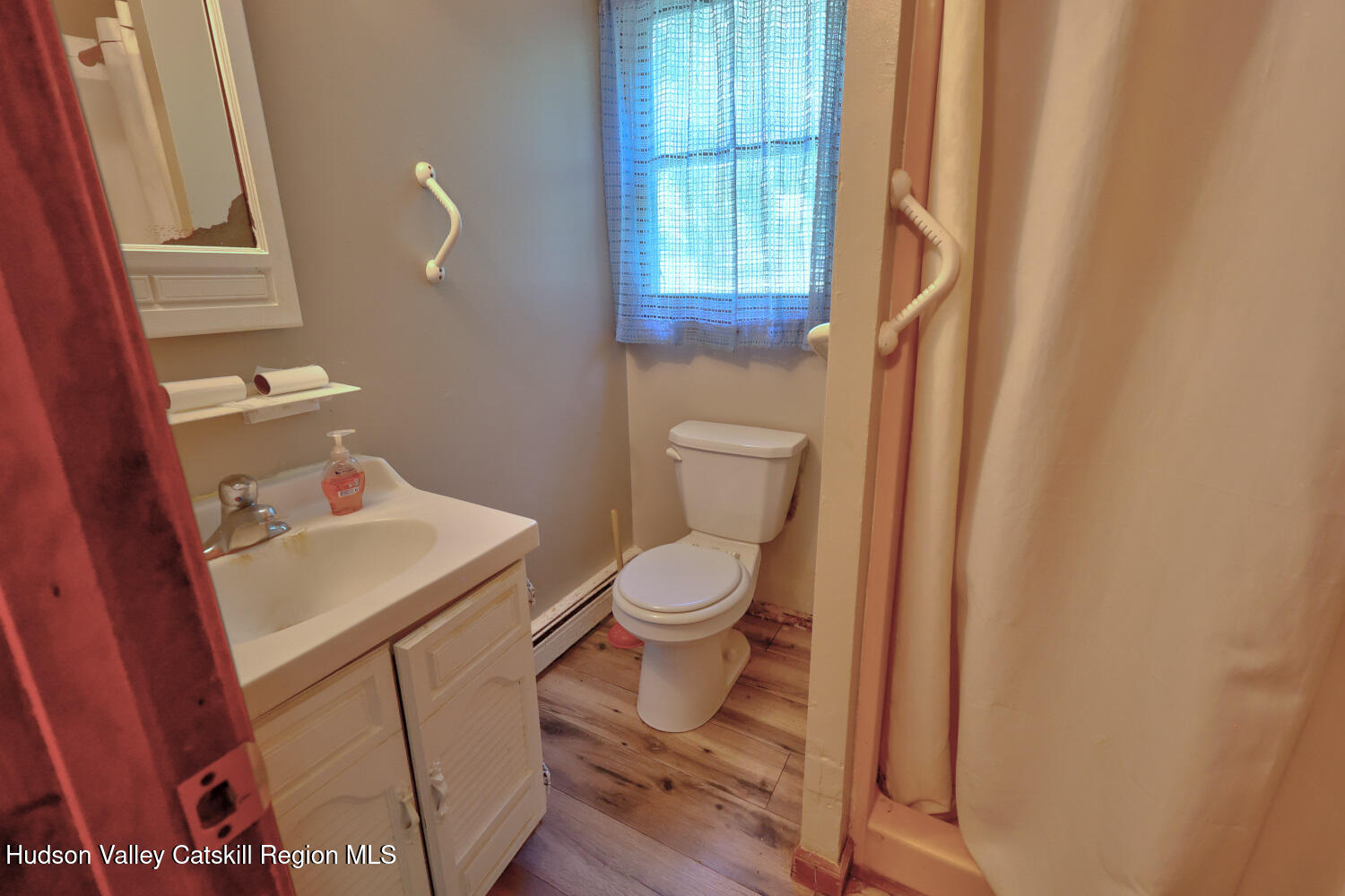 70 Horseneck Road Freehold, NY 12431 - Photo 14 of 70 a bathroom with a toilet a sink and a window