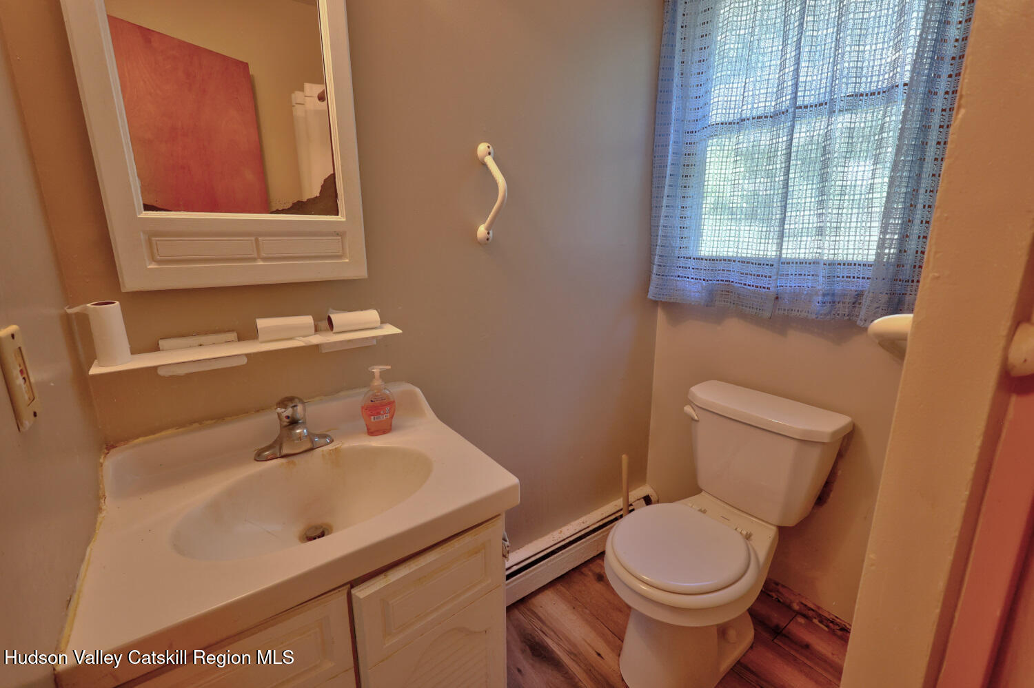 70 Horseneck Road Freehold, NY 12431 - Photo 15 of 70 a bathroom with a sink a toilet and a mirror