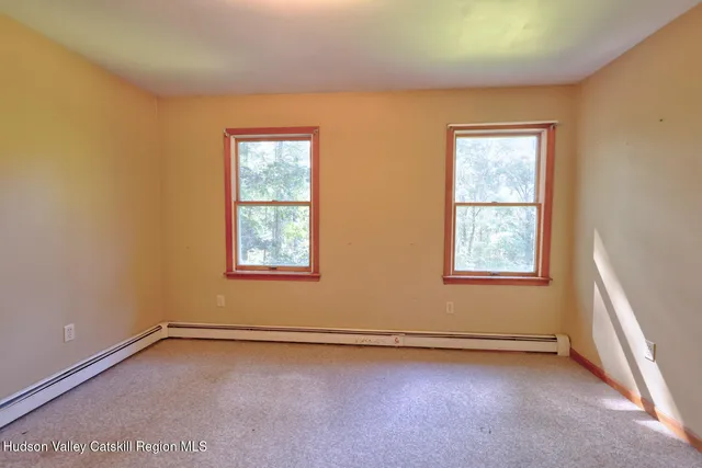 a bedroom with a bed and a chair