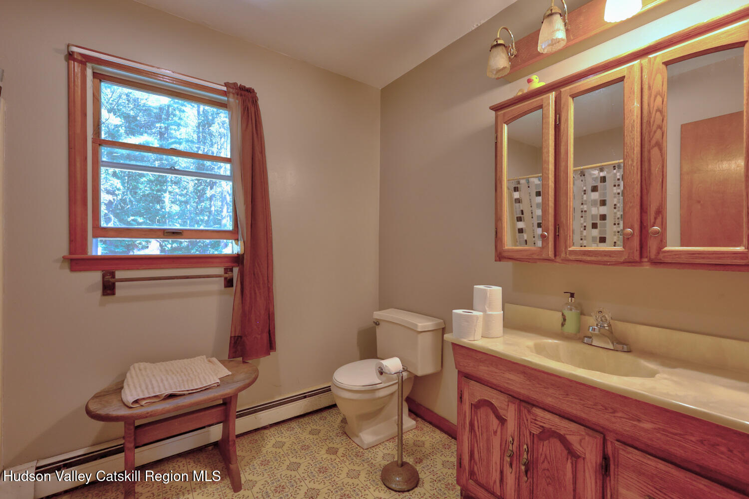 70 Horseneck Road Freehold, NY 12431 - Photo 43 of 70 a bathroom with a granite countertop toilet sink and mirror