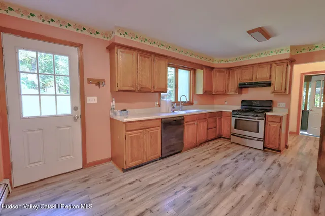 a kitchen with stainless steel appliances granite countertop a sink stove and cabinets