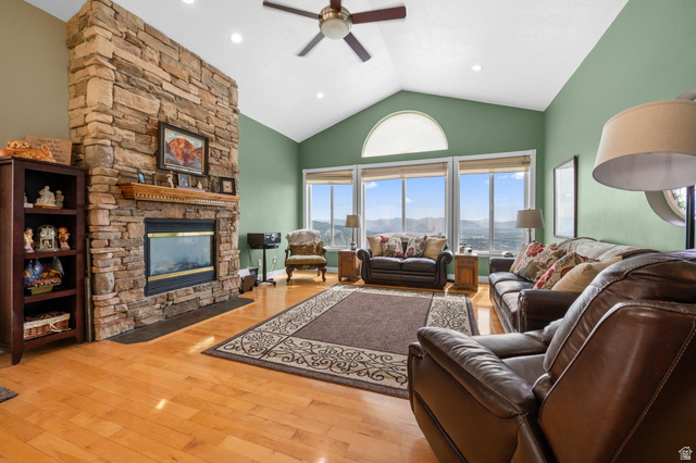 708 Eagle Rdg Drive Bountiful, UT 84010 - Photo 5 of 69 Spacious living area featuring a floor-to-ceiling stone fireplace, vaulted ceilings, and large windows with arched transoms