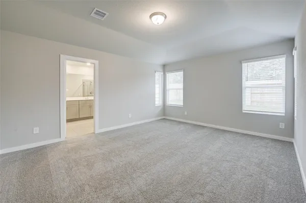 an empty room with windows and closet