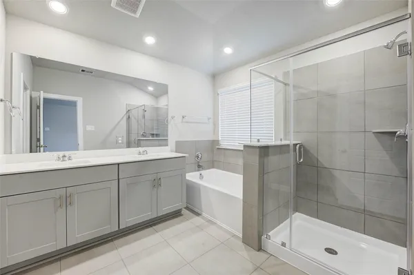 a bathroom with a shower sink and mirror