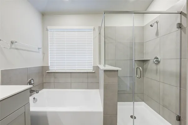 a bathroom with a bathtub and shower
