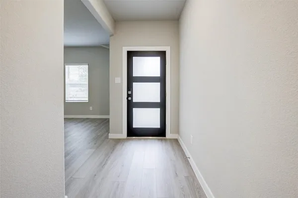 wooden floor in a empty room with a window
