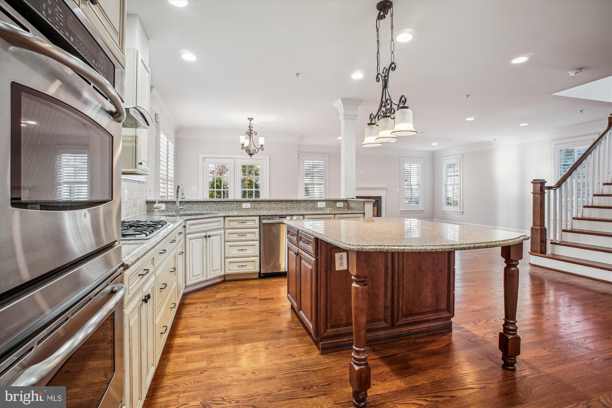 5512 Greentree Road Bethesda, MD 20817 - Photo 12 of 75 a large kitchen with stainless steel appliances a sink dishwasher a stove and a dining table with wooden floor