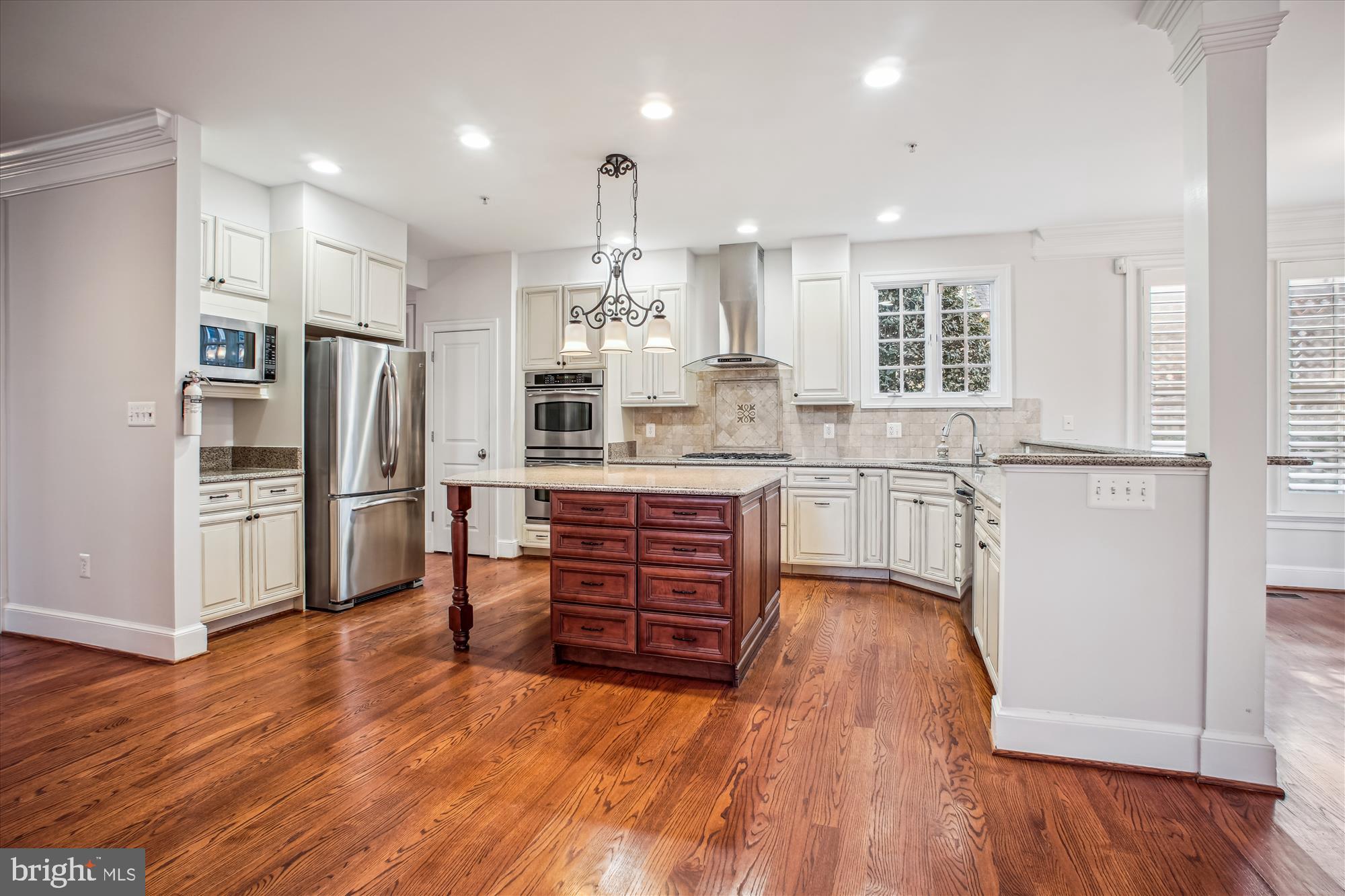 5512 Greentree Road Bethesda, MD 20817 - Photo 13 of 75 a kitchen with stainless steel appliances a refrigerator and wooden floors