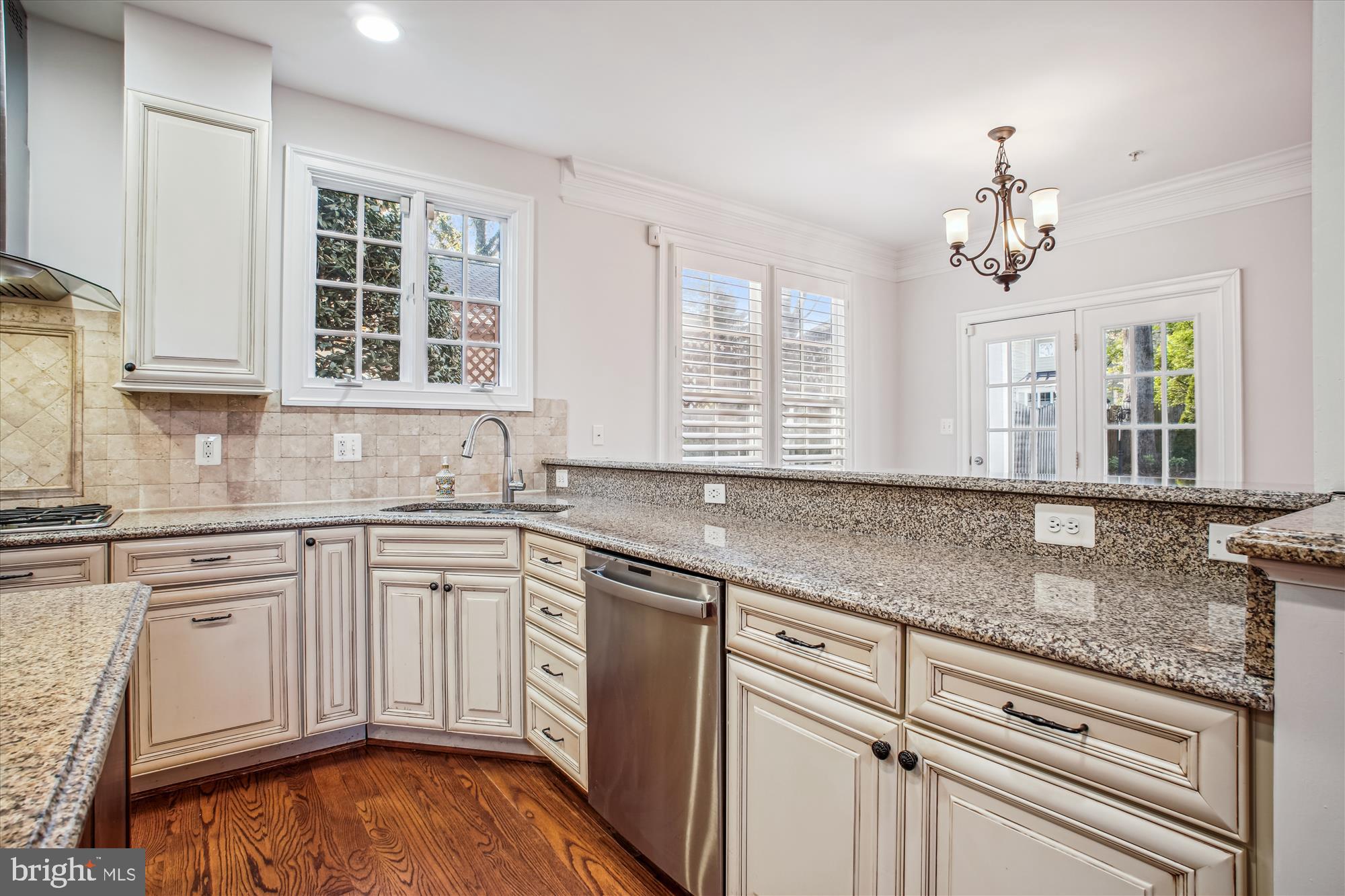 5512 Greentree Road Bethesda, MD 20817 - Photo 15 of 75 a kitchen with granite countertop white cabinets stainless steel appliances a sink and a window