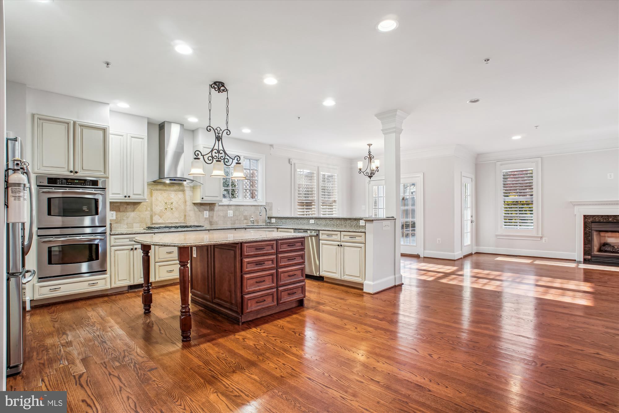 5512 Greentree Road Bethesda, MD 20817 - Photo 18 of 75 a large kitchen with stainless steel appliances granite countertop a stove and a wooden floors