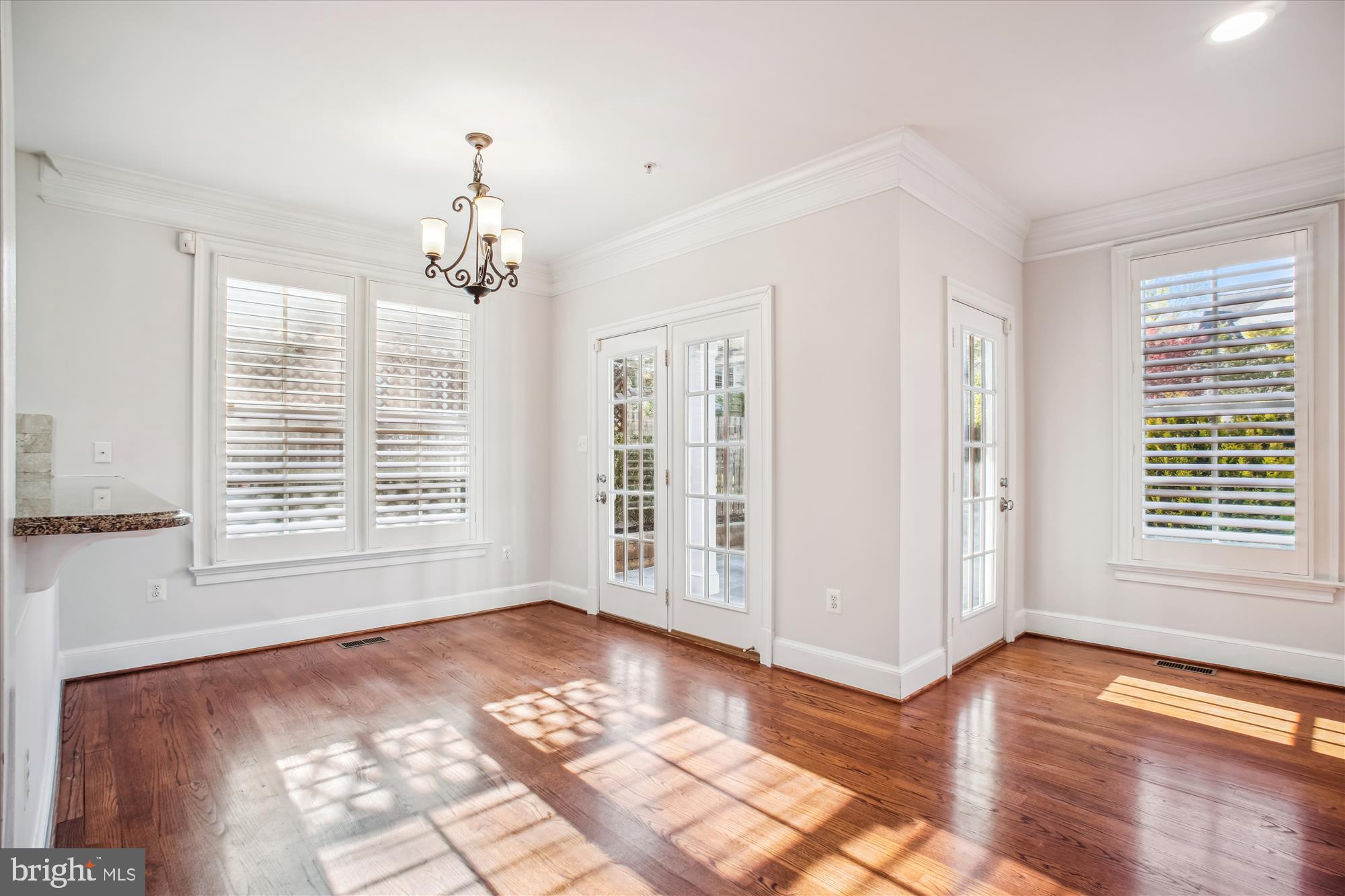 5512 Greentree Road Bethesda, MD 20817 - Photo 20 of 75 a view of a livingroom with a chandelier wooden floor and windows