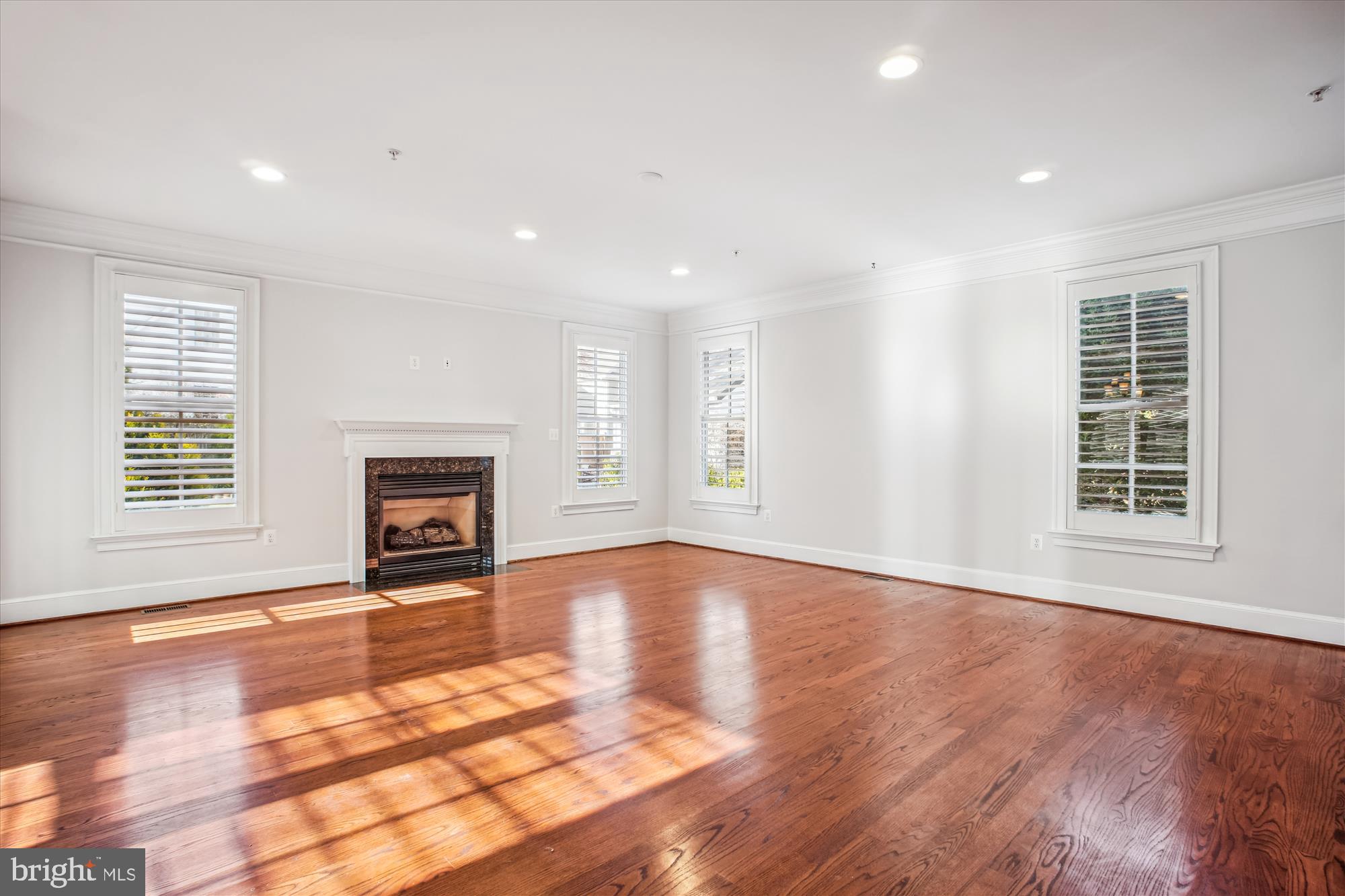 5512 Greentree Road Bethesda, MD 20817 - Photo 22 of 75 an empty room with wooden floor and fireplace