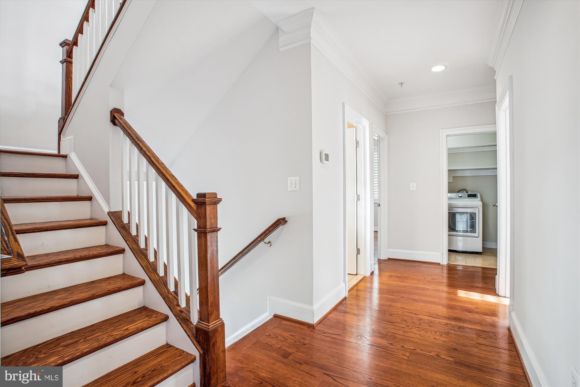 5512 Greentree Road Bethesda, MD 20817 - Photo 29 of 75 a view of a hallway with wooden floor and stairs