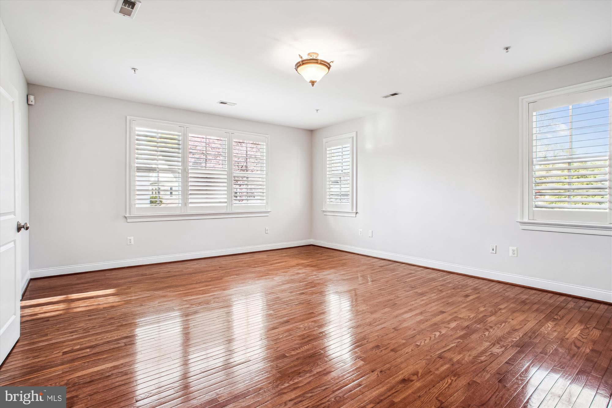 5512 Greentree Road Bethesda, MD 20817 - Photo 30 of 75 a view of an empty room with wooden floor and a window