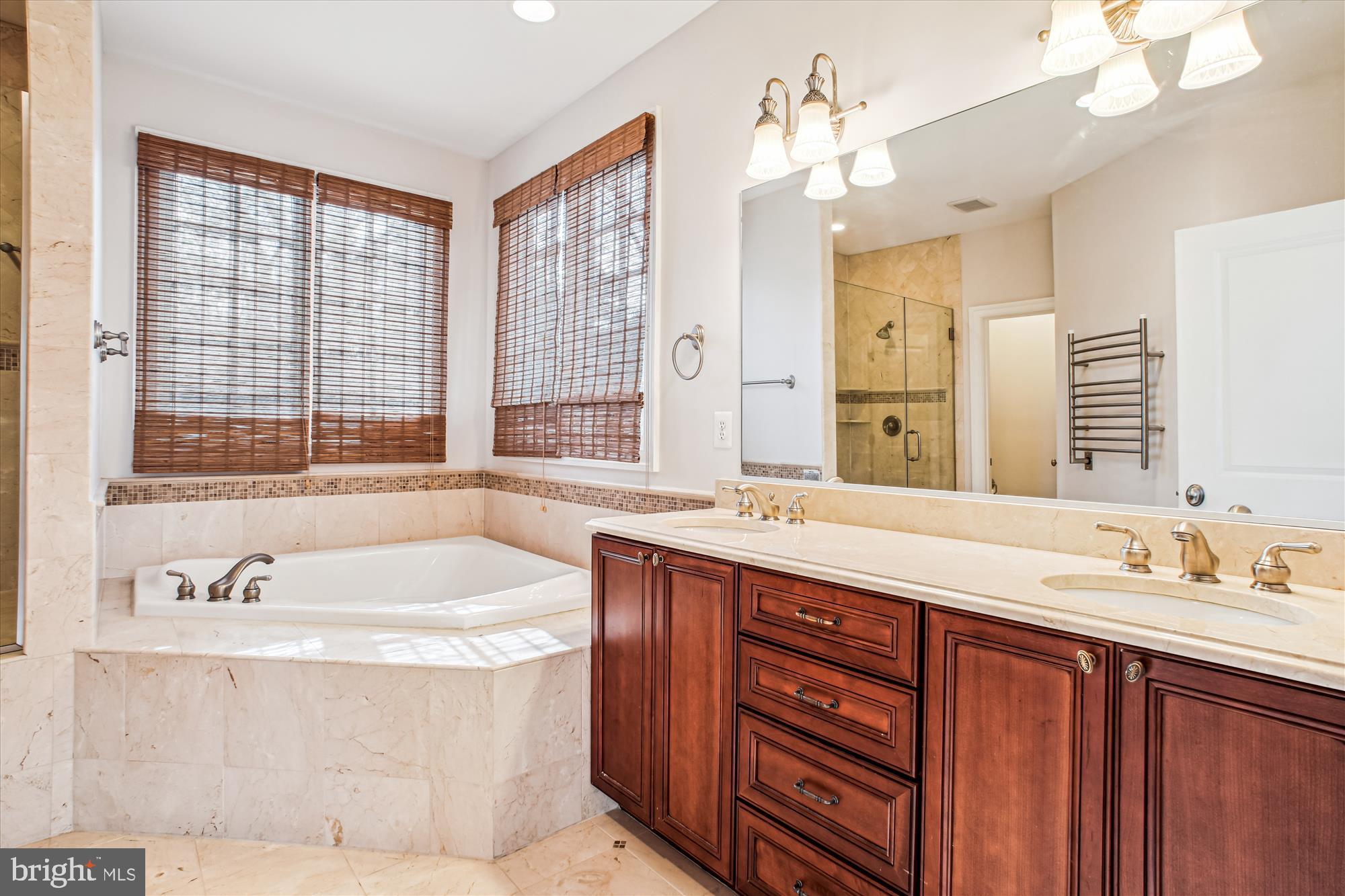 5512 Greentree Road Bethesda, MD 20817 - Photo 36 of 75 a bathroom with a tub double sink large mirror and a window
