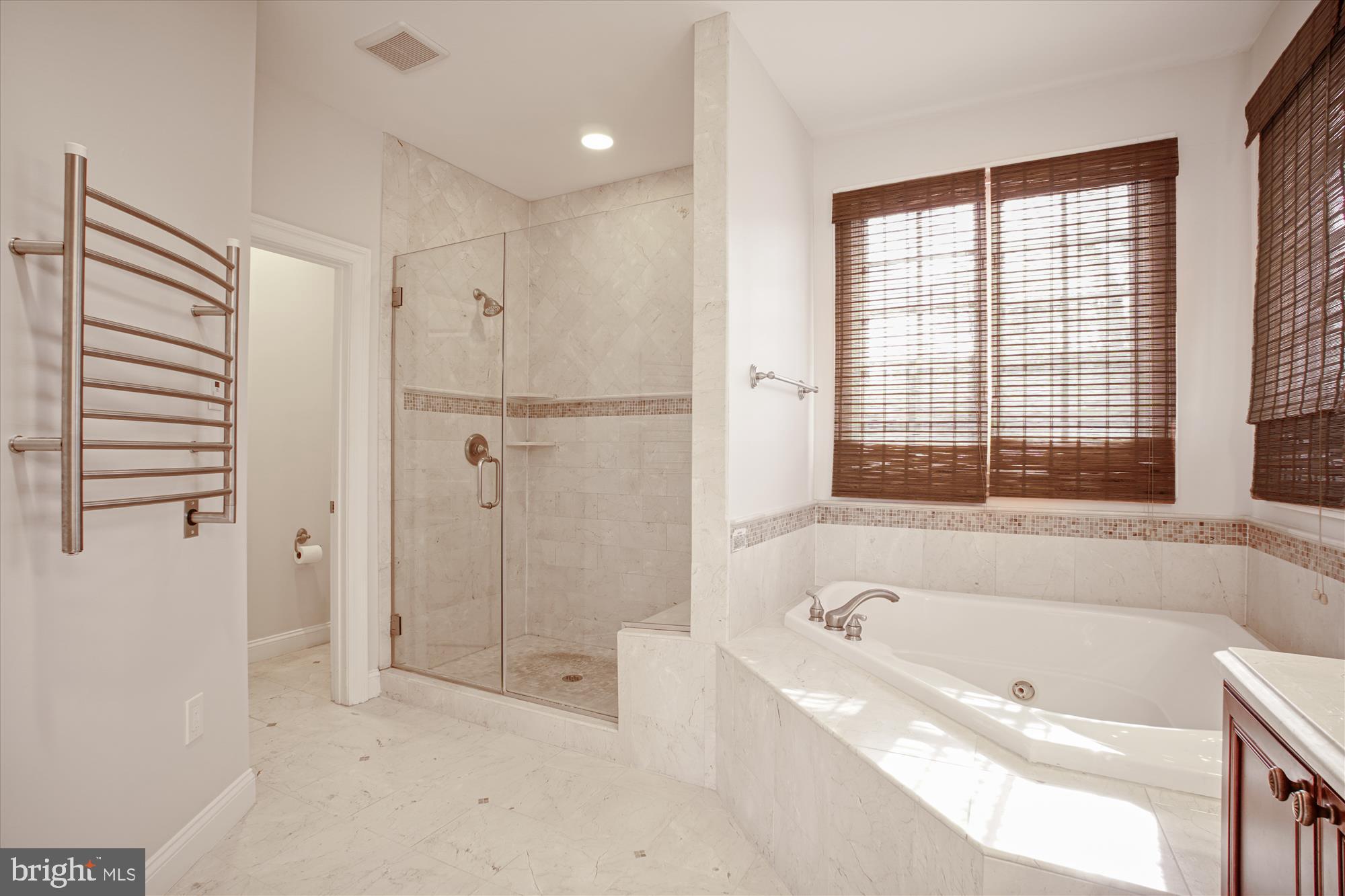 5512 Greentree Road Bethesda, MD 20817 - Photo 37 of 75 a spacious bathroom with a bathtub and a shower