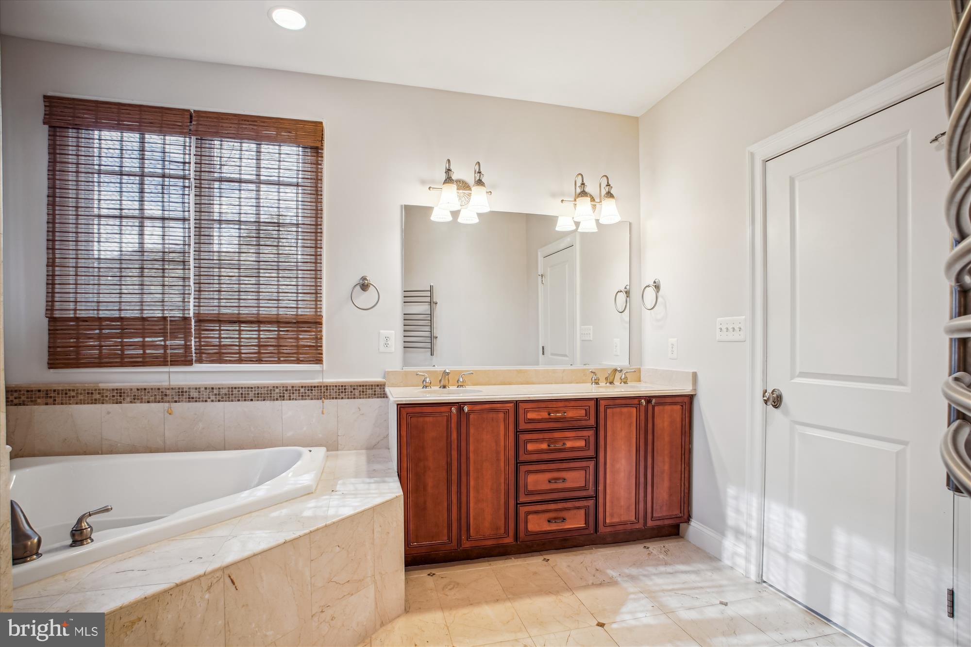 5512 Greentree Road Bethesda, MD 20817 - Photo 38 of 75 a spacious bathroom with a tub sink and mirror