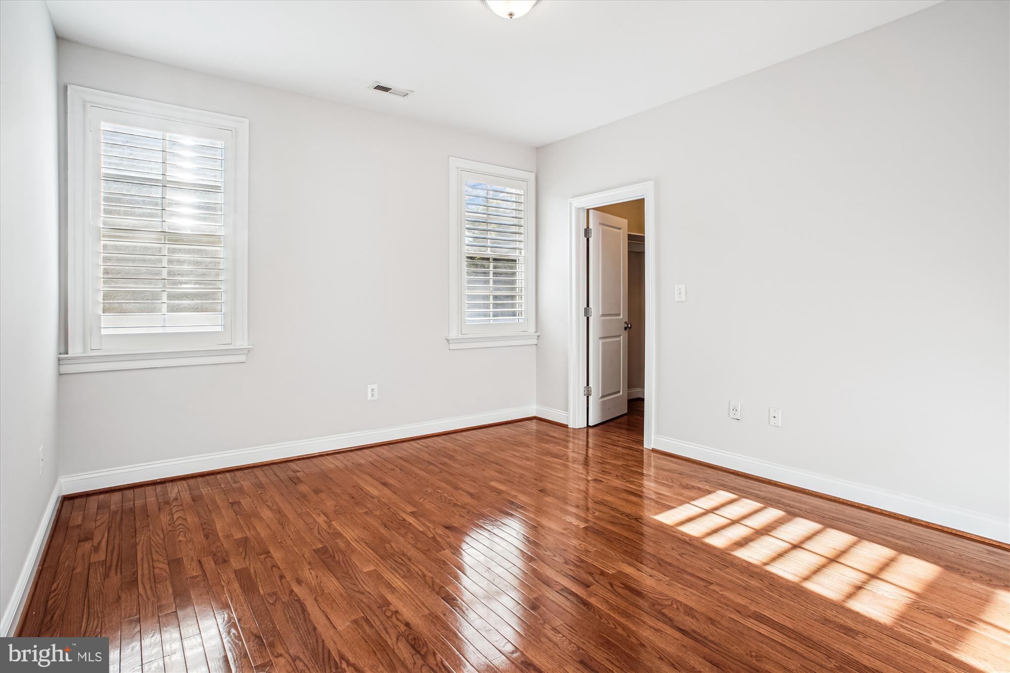 5512 Greentree Road Bethesda, MD 20817 - Photo 39 of 75 an empty room with wooden floor and windows