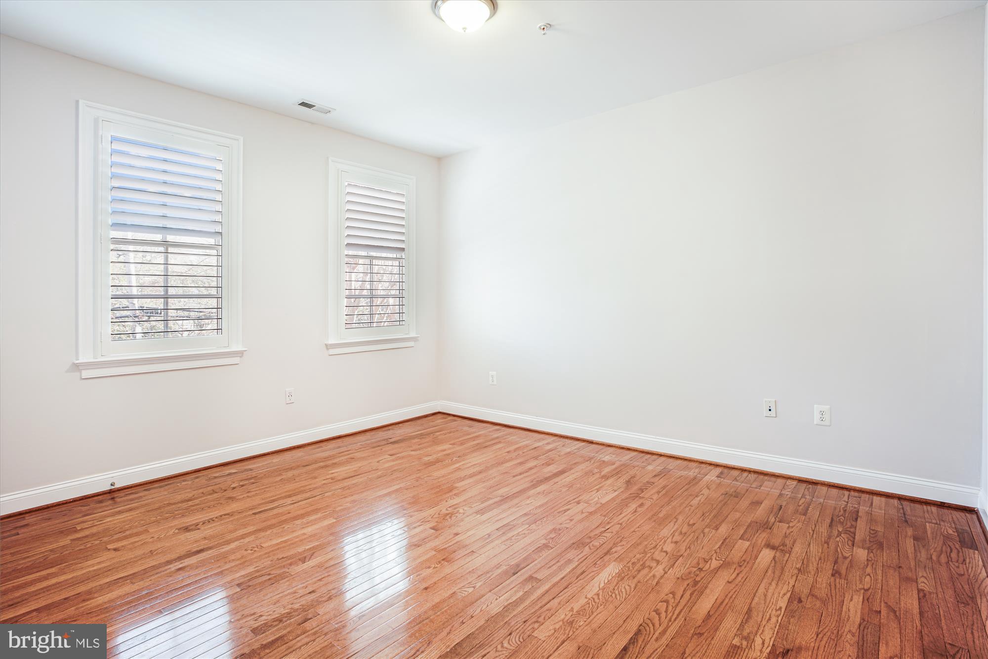 5512 Greentree Road Bethesda, MD 20817 - Photo 42 of 75 an empty room with wooden floor and windows