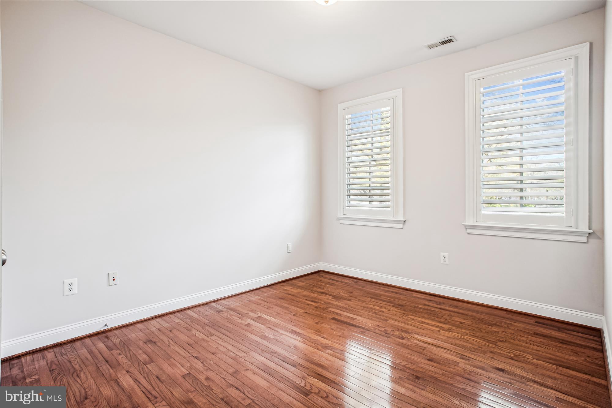 5512 Greentree Road Bethesda, MD 20817 - Photo 43 of 75 an empty room with wooden floor and windows