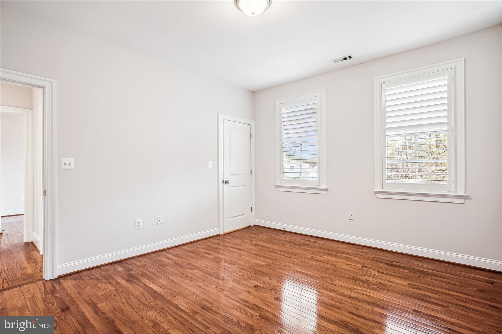 5512 Greentree Road Bethesda, MD 20817 - Photo 45 of 75 an empty room with wooden floor and windows