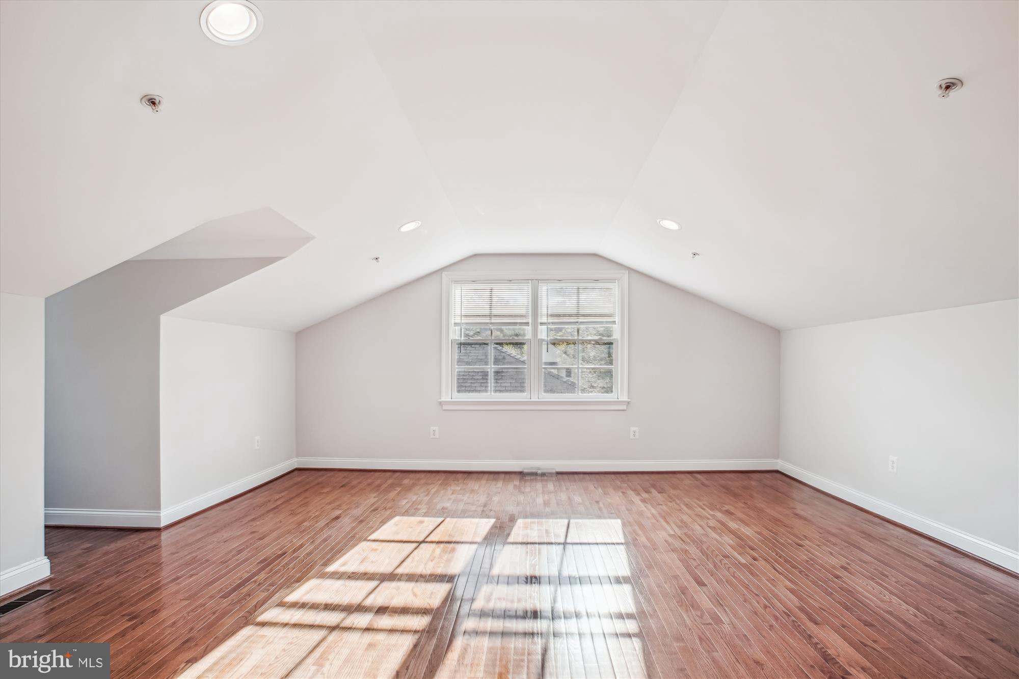 5512 Greentree Road Bethesda, MD 20817 - Photo 53 of 75 an empty room with wooden floor and windows