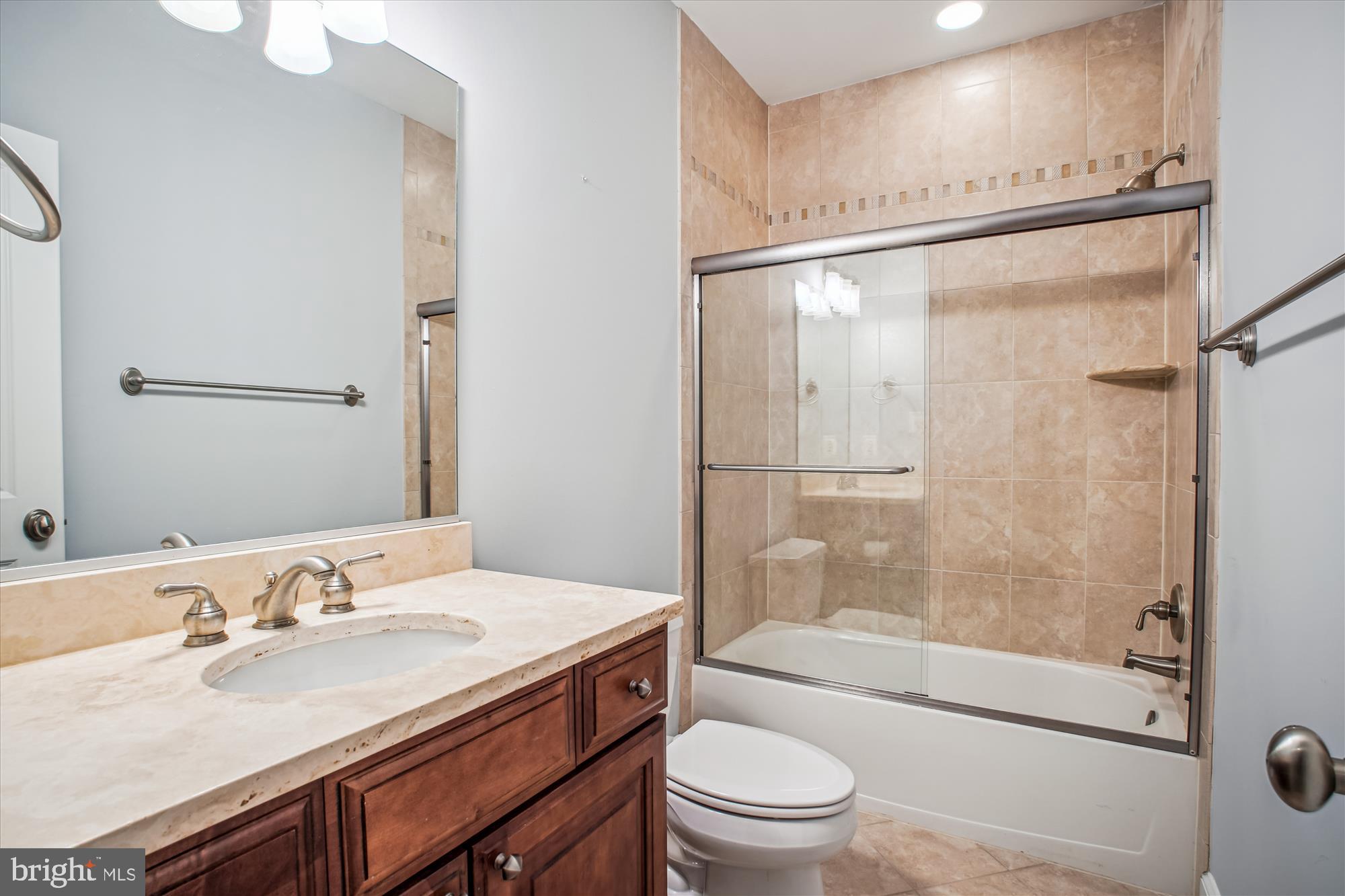 5512 Greentree Road Bethesda, MD 20817 - Photo 57 of 75 a bathroom with a granite countertop sink toilet and shower