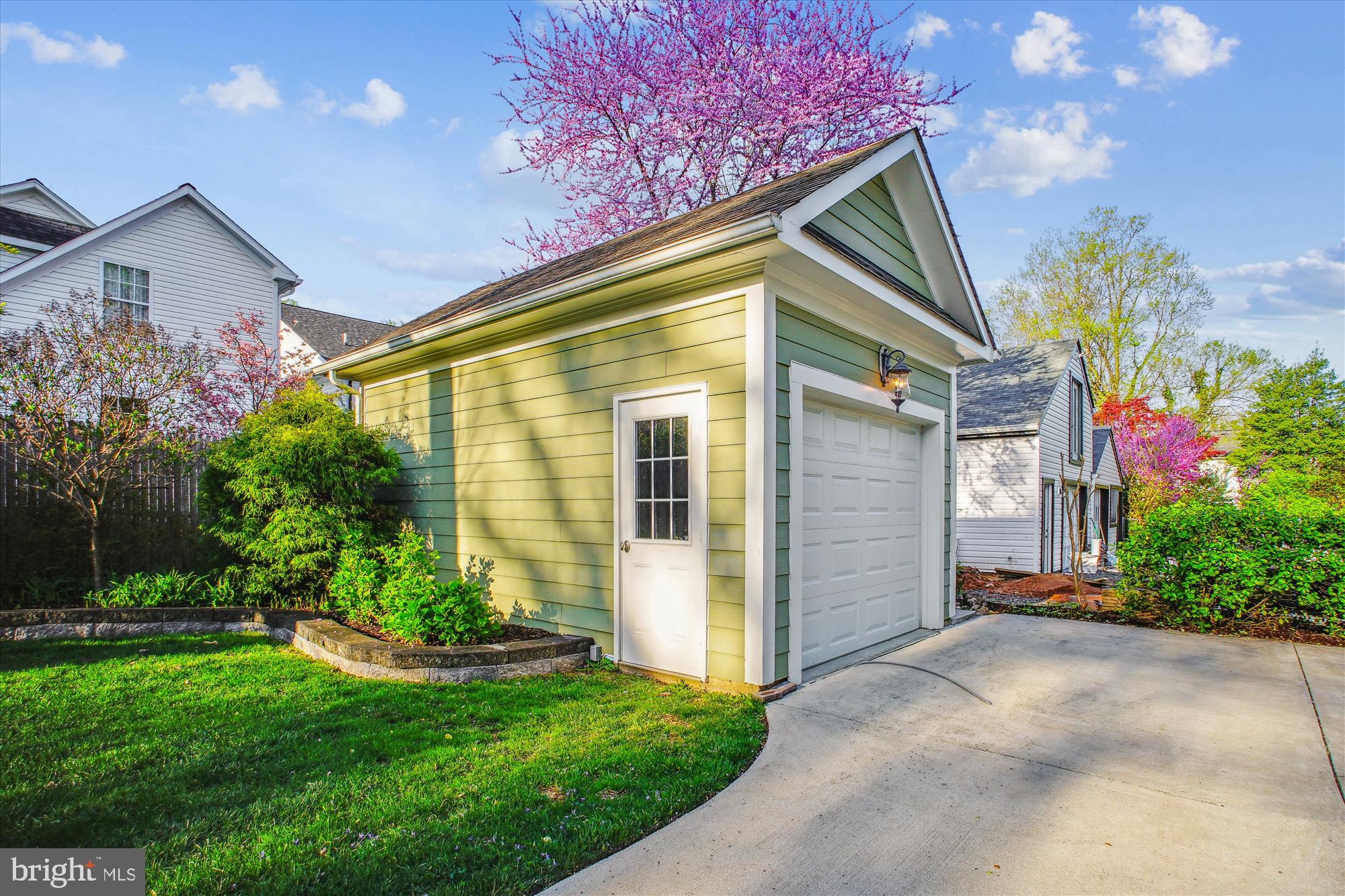 5512 Greentree Road Bethesda, MD 20817 - Photo 60 of 75 a front view of a house with a yard and garage