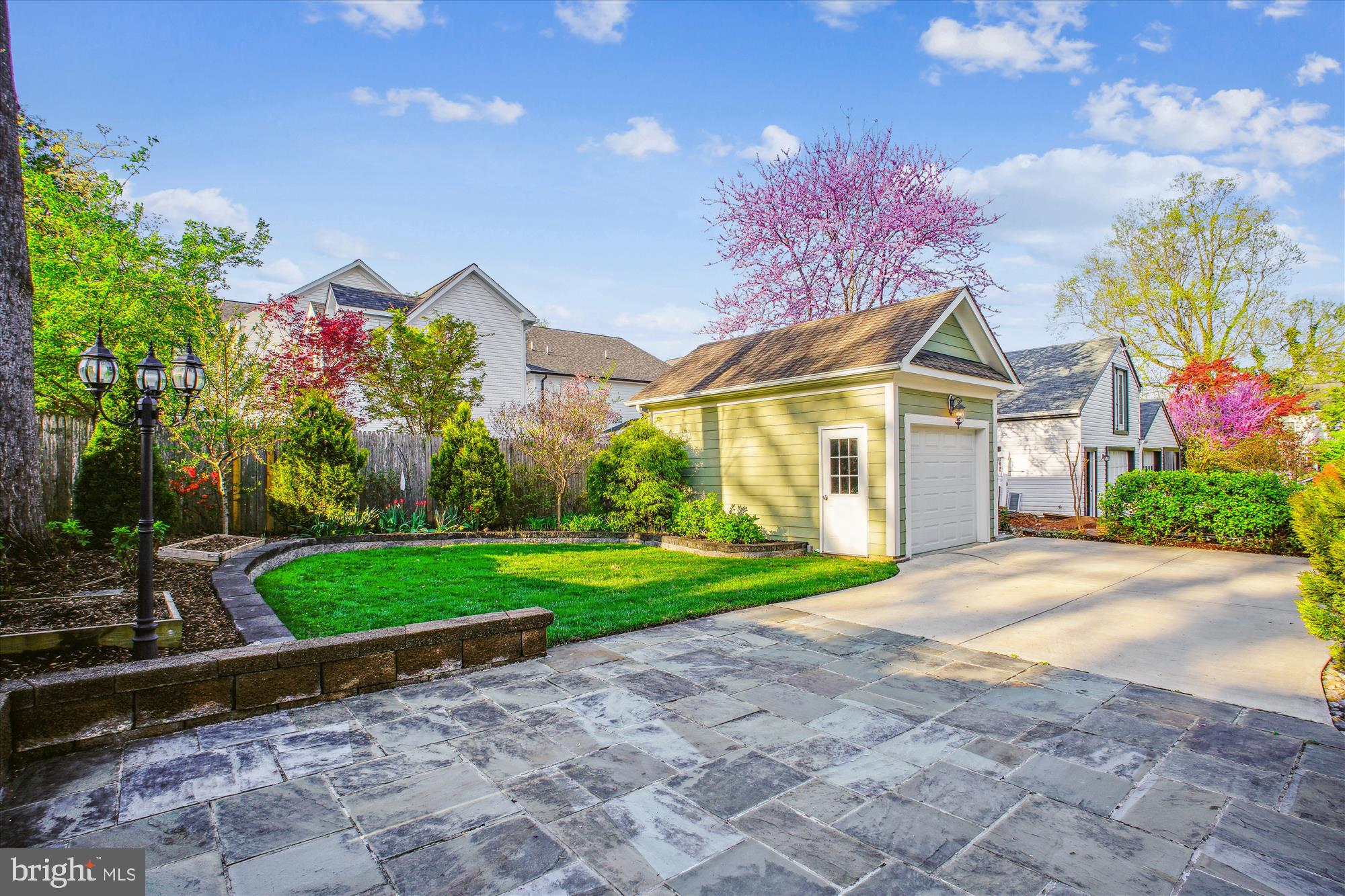 5512 Greentree Road Bethesda, MD 20817 - Photo 67 of 75 a front view of a house with a yard and garage