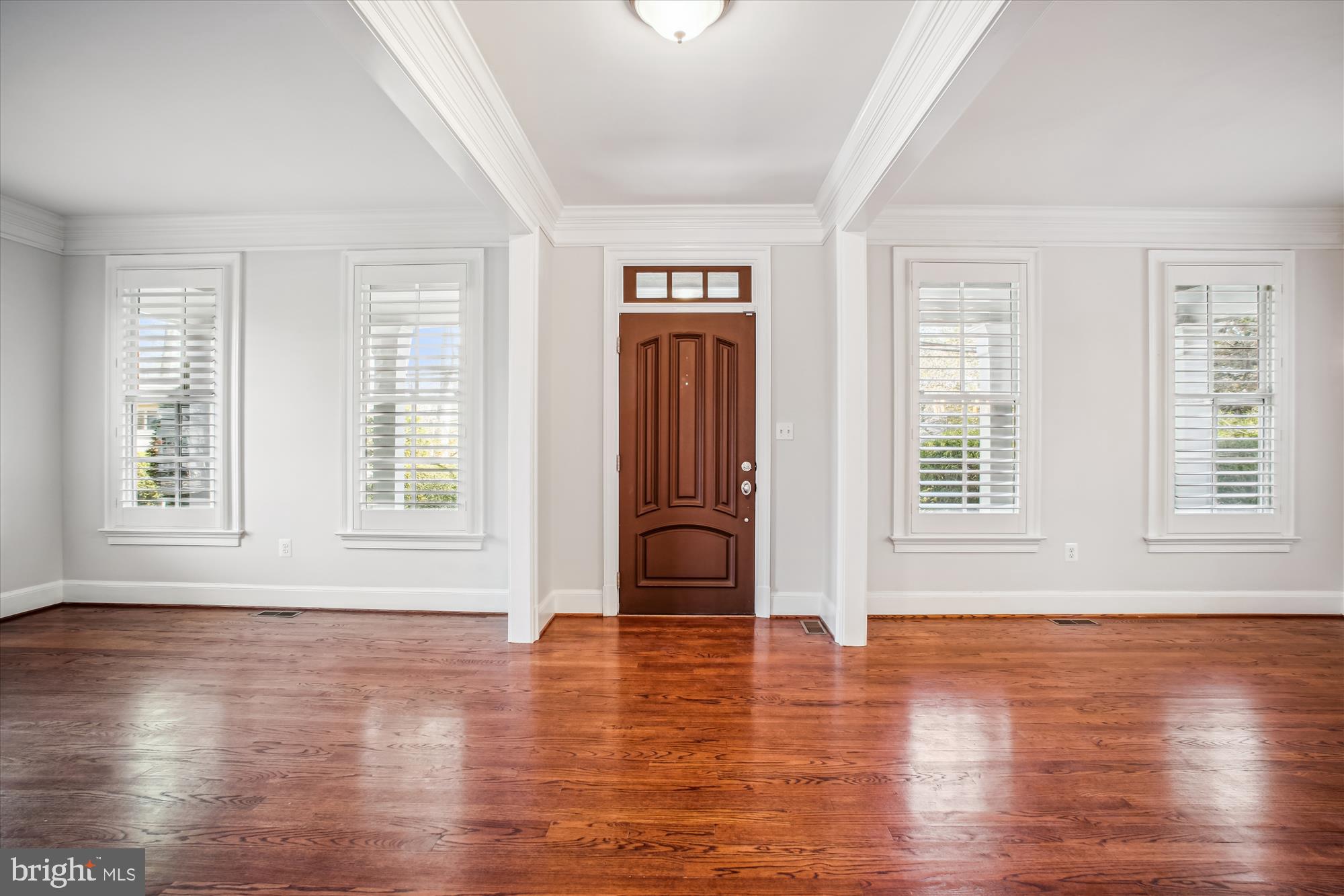 5512 Greentree Road Bethesda, MD 20817 - Photo 6 of 75 an empty room with wooden floor and windows