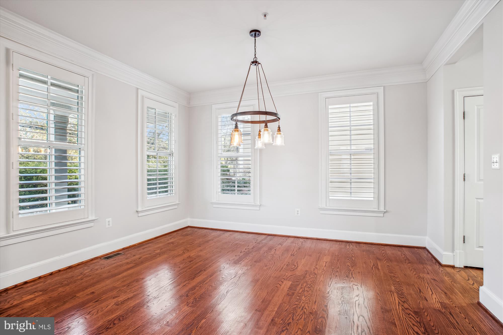 5512 Greentree Road Bethesda, MD 20817 - Photo 9 of 75 a view of an empty room with wooden floor and a window