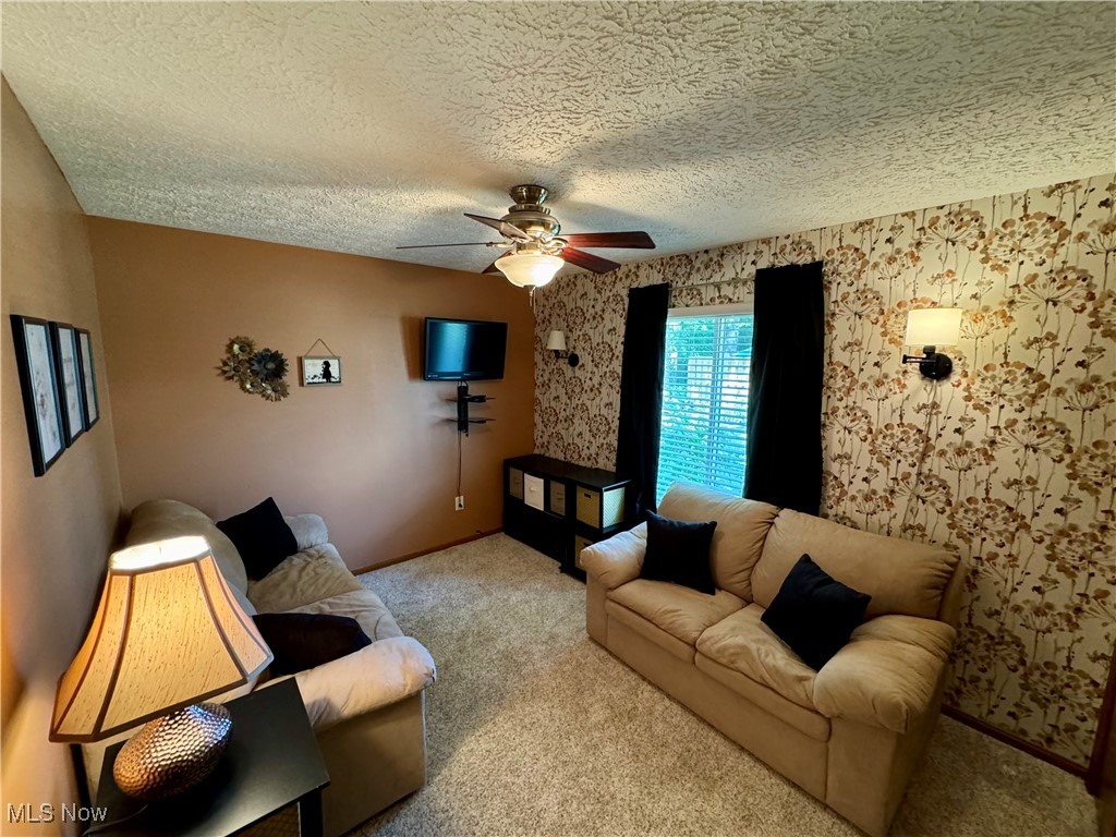 1499 Welch Road Painesville, OH 44077 - Photo 17 of 22 Carpeted bedroom featuring a textured ceiling, carpet flooring, and ceiling fan