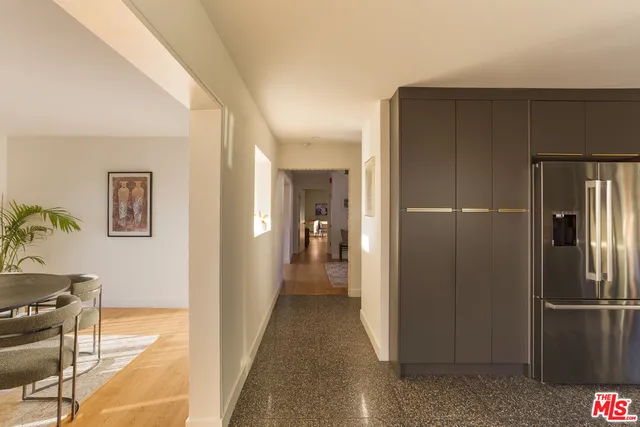 a view of a refrigerator in kitchen and livingroom