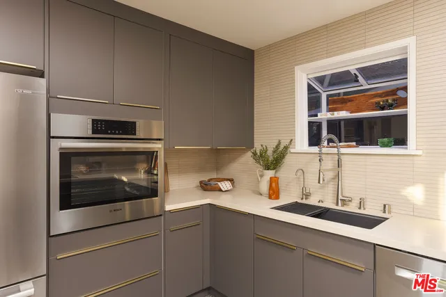 a kitchen with a sink and cabinets