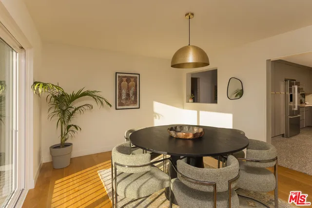 a dining room with table chairs and wooden floor