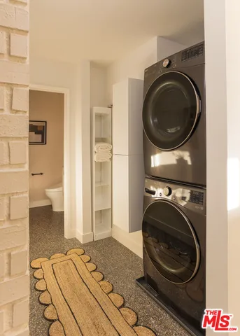 a view of a bedroom with washer and dryer