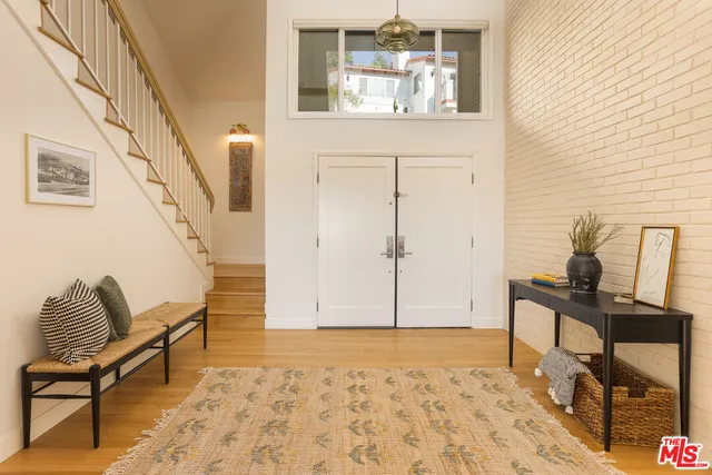 a view of a hallway with furniture and natural light