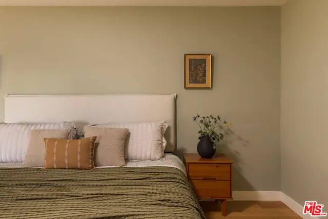 a bed sitting in a bedroom next to a wall