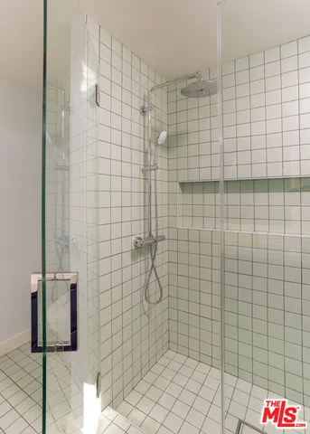 a view of a hallway with wooden floor and a living room
