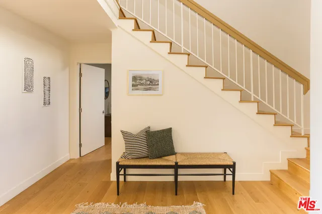 a view of entryway and hall with wooden floor