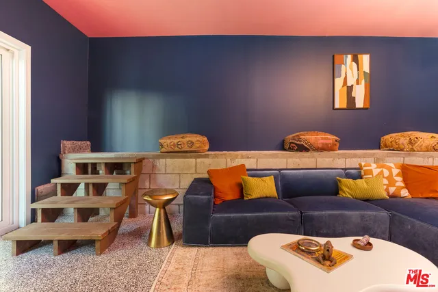 a living room with furniture a floor to ceiling window and floor to ceiling window